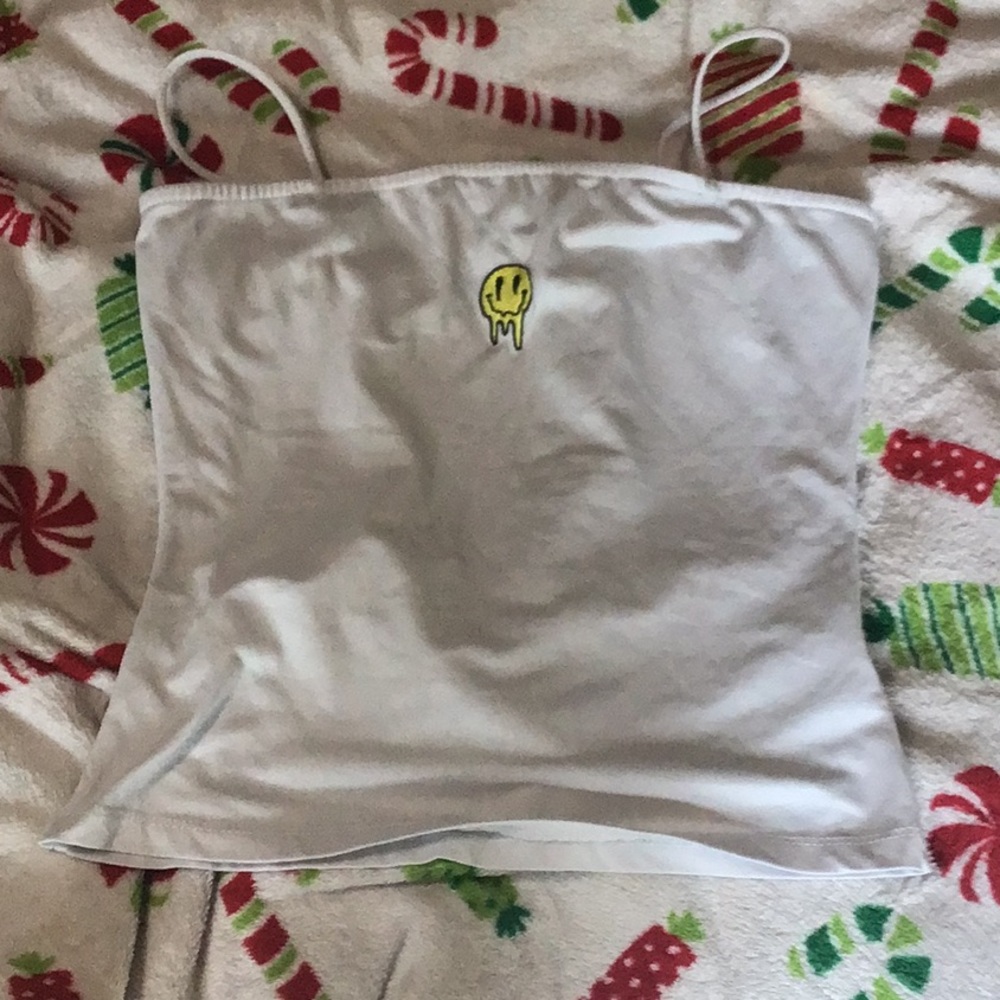 white tank top, yellow smiley face on front
